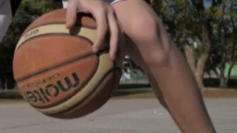 Basketball player dribbling ball